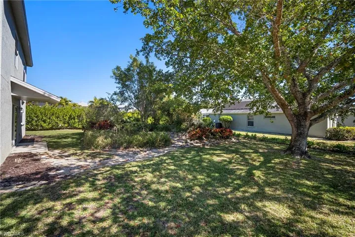 View of grassy yard featuring a patio