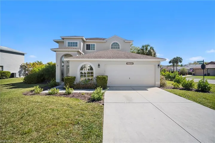 View of front of home featuring a front lawn, stucco siding, concrete driveway, an attached garage, and a shingled roof