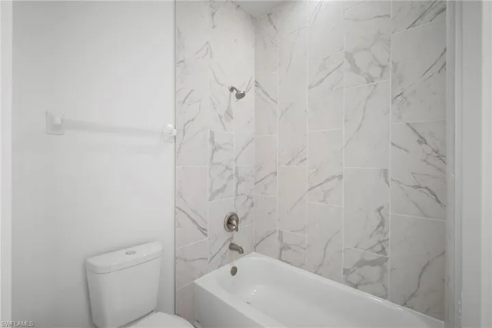 Bathroom with toilet and shower / washtub combination