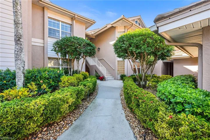 Walk way to Covered Double Door Entry.  Detached 2 car garage included with home.