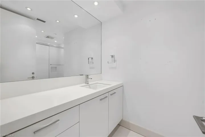 Bathroom is sleek and offers plenty of counter space and storage for your guest.