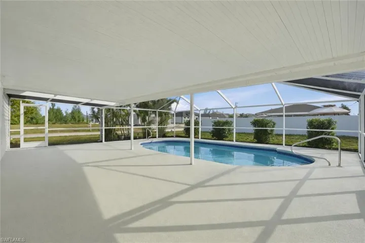 Outdoor pool with a lanai, a sunroom, and a patio