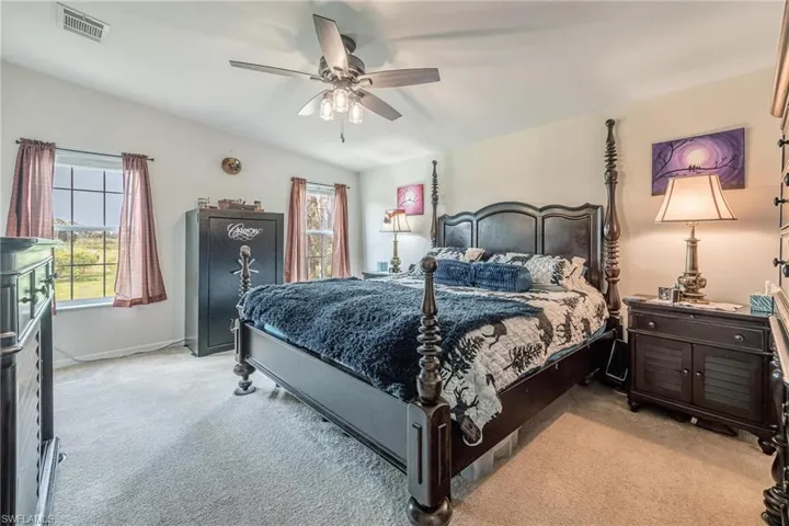 Bedroom featuring light carpet and ceiling fan