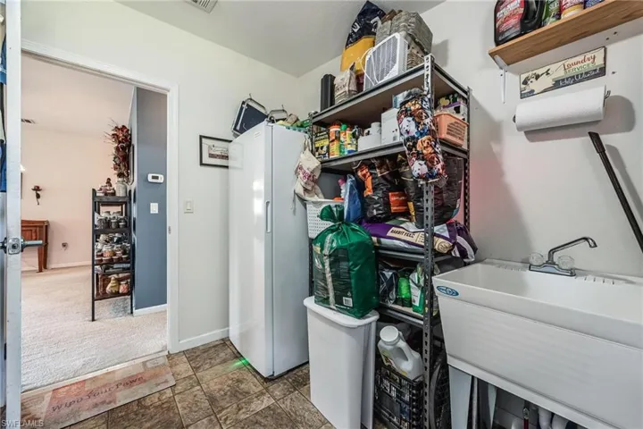 Laundry room with sink and tile patterned floors