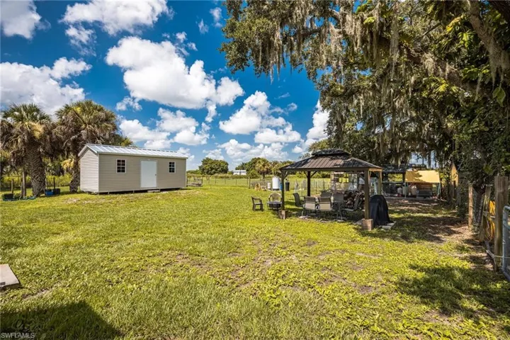 View of yard with an outdoor structure and a gazebo