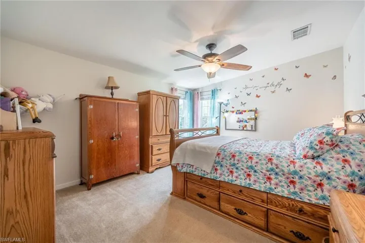 Bedroom featuring light carpet and ceiling fan