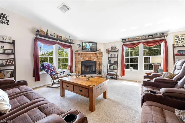 Living room featuring a fireplace and carpet