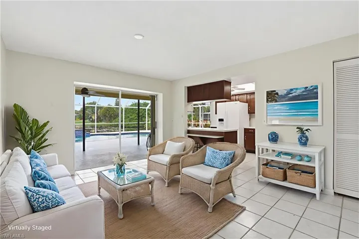 DEN LEADING OUT TO OUTDOOR LIVING SPACE - VIRTUALLY STAGED
