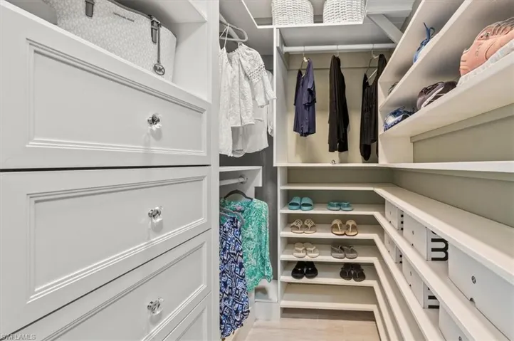 Spacious closet featuring light hardwood / wood-style flooring