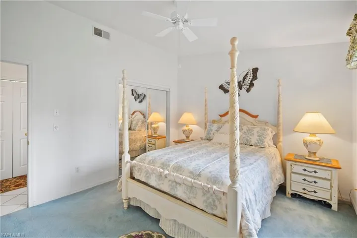 Carpeted bedroom featuring a closet and ceiling fan