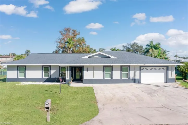 Single story home featuring a front lawn and a garage