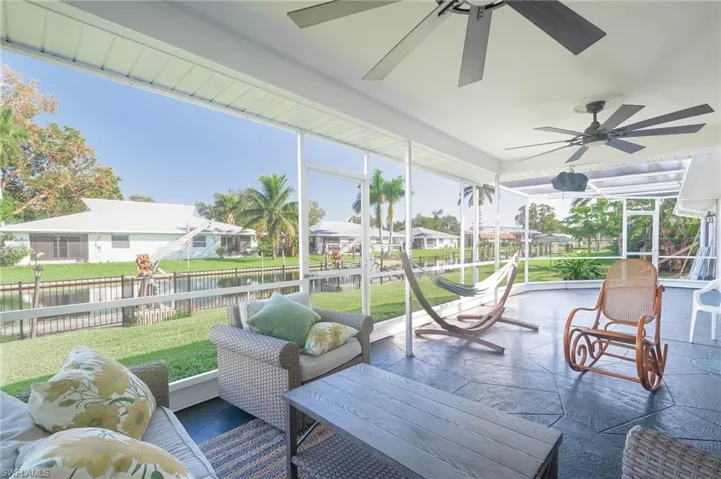 Sunroom / solarium with a water view and ceiling fan