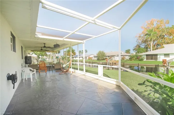 Unfurnished sunroom featuring a water view and ceiling fan