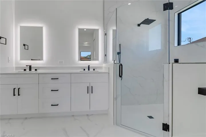Bathroom with a shower with door and vanity