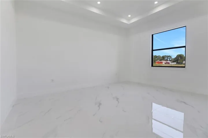 Spare room featuring a tray ceiling
