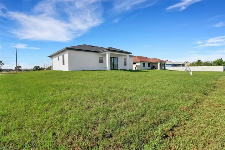 Back of property with a yard