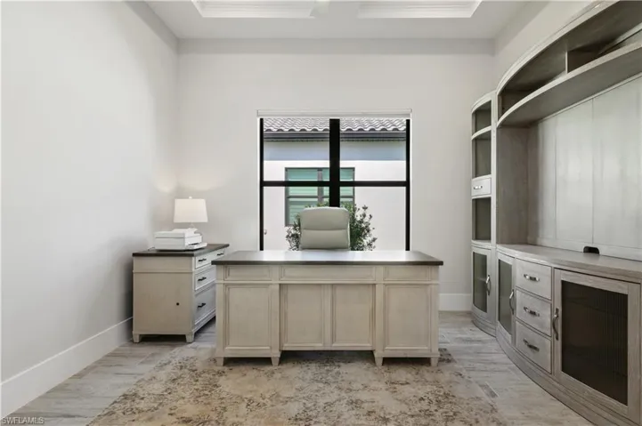 Office space featuring crown molding and light wood-type flooring