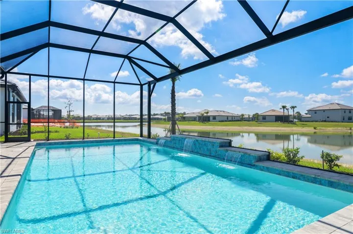 Swimming pool with a water view, a lanai, and a residential view
