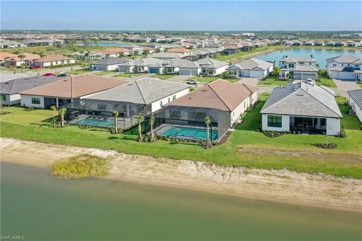Aerial view of residential area featuring a nearby body of water