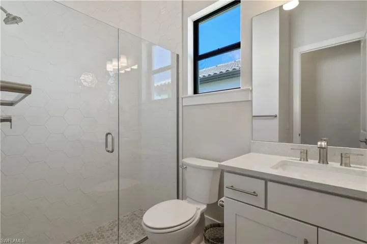 Bathroom with a stall shower and vanity