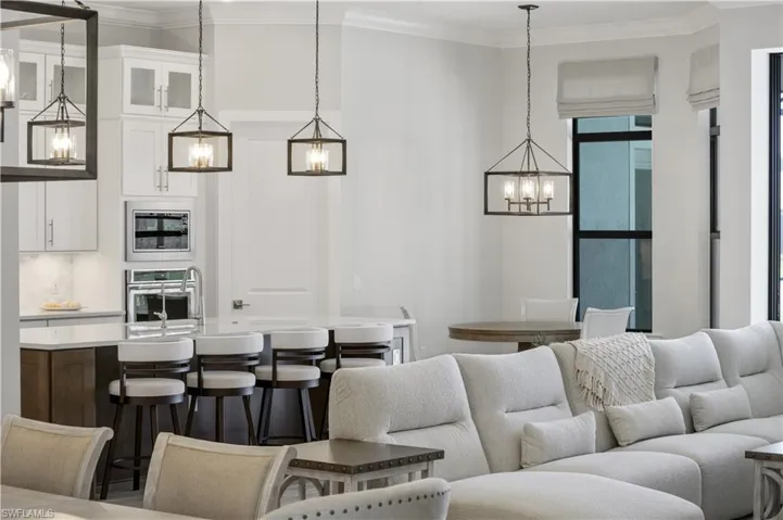 Living area with a chandelier and ornamental molding