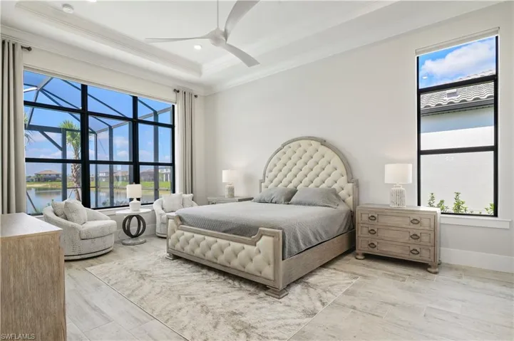Bedroom featuring ornamental molding, a water view, recessed lighting, ceiling fan, and light wood-type flooring