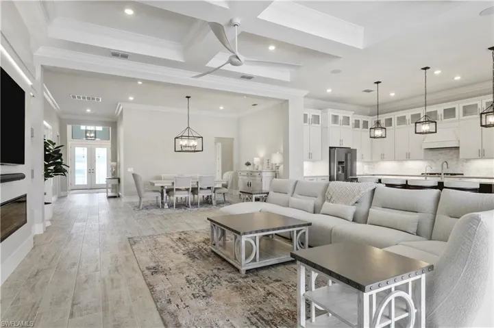 Living room featuring recessed lighting, light wood finished floors, and ornamental molding
