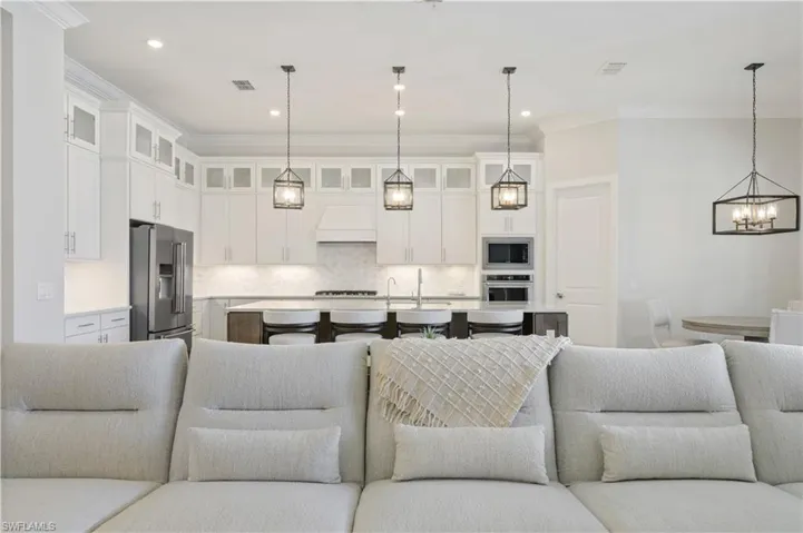 Living room featuring ornamental molding, a chandelier, and recessed lighting