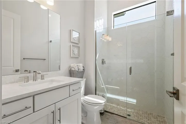 Bathroom featuring vanity and a shower stall
