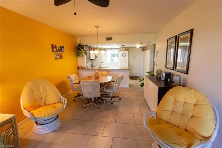 Dining room with light tile patterned flooring and ceiling fan