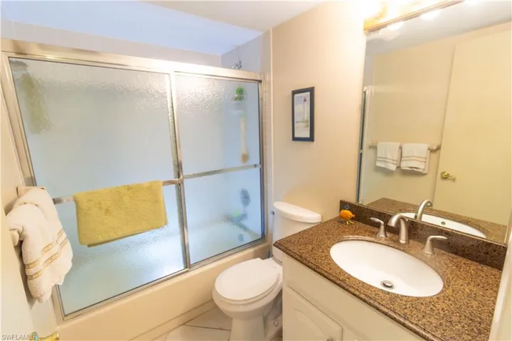 Bathroom with vanity, combined bath / shower with glass door, and tile patterned floors