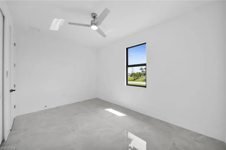 Unfurnished room featuring baseboards and a ceiling fan