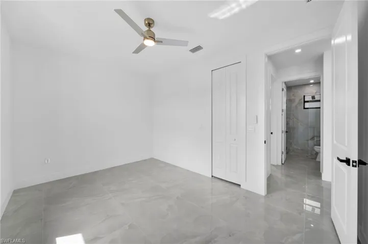 Unfurnished bedroom featuring a closet, a ceiling fan, and recessed lighting