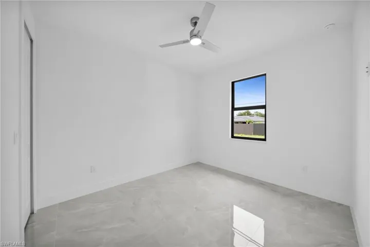 Unfurnished room featuring a ceiling fan