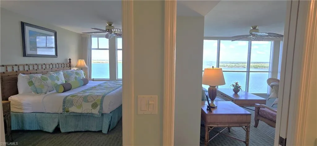 Bedroom with a water view, carpet floors, and multiple windows