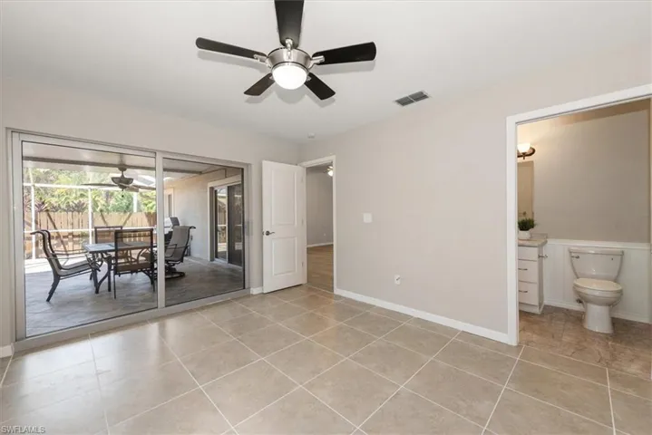 Dining space with ceiling fan, light tile patterned floors, and a sunroom