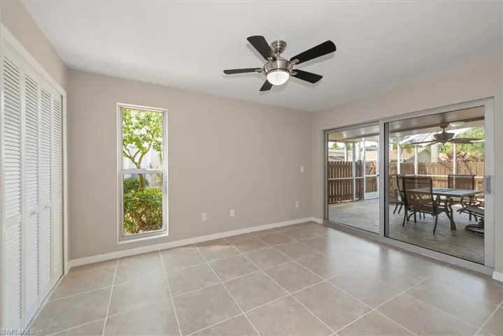 Dining room with light tile patterned floors and a ceiling fan