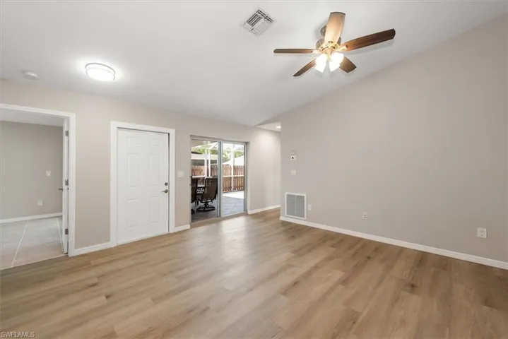 Unfurnished living room featuring light wood-type flooring and a ceiling fan