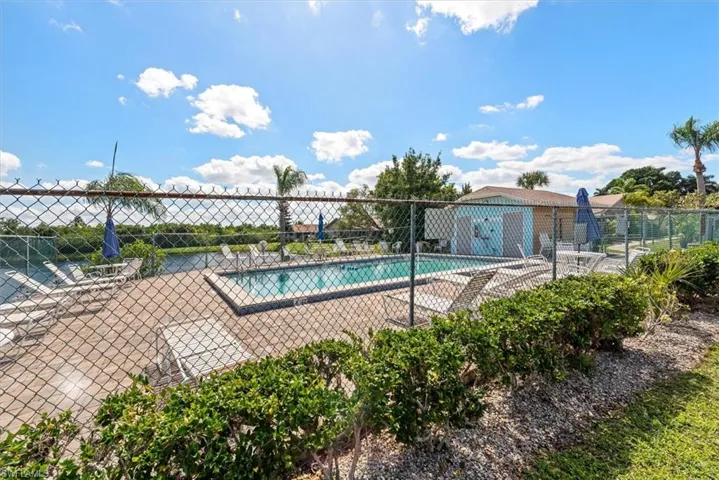 Community pool with a patio