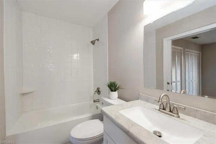 Full bath featuring washtub / shower combination and vanity