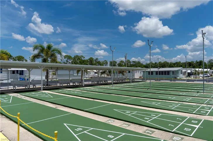 Multiple shuffleboard courts featuring green surfacing and white markings