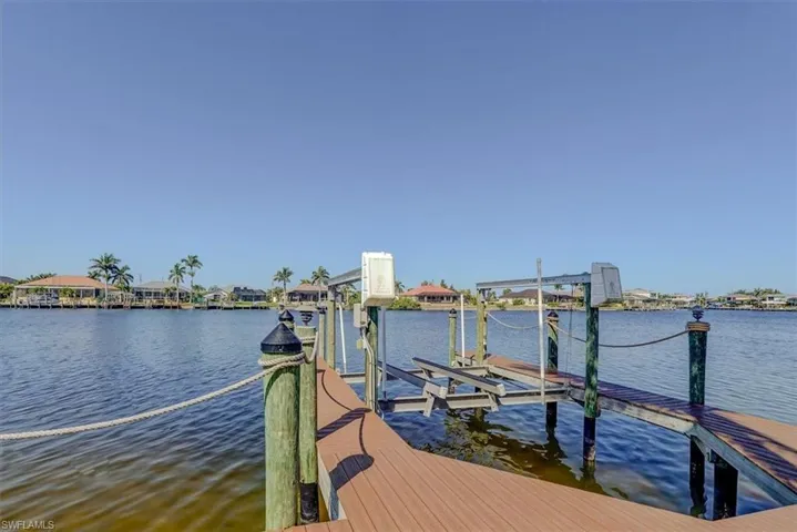 Dock area featuring boat lift and a water view