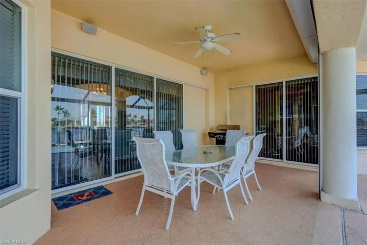 View of patio featuring outdoor dining area and a ceiling fan
