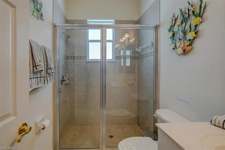 Full bath with a shower stall, toilet, and vanity