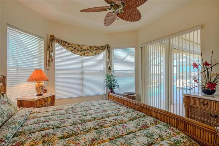 Bedroom featuring a ceiling fan and access to outside