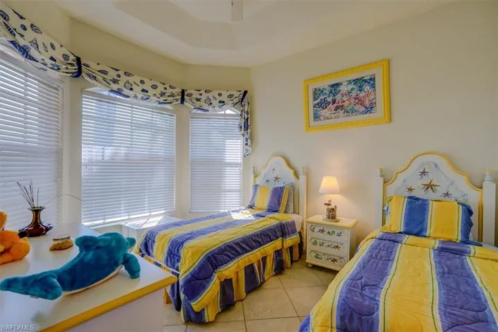 Bedroom featuring tile patterned flooring and ceiling fan