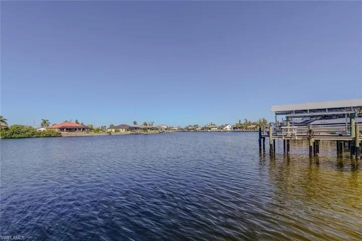 Dock area with boat lift and a water view