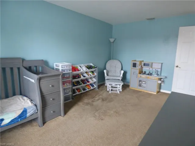 View of large carpeted bedroom