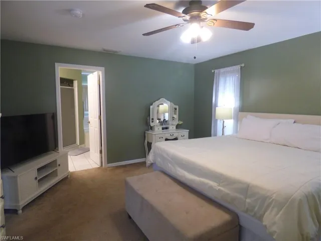 Huge Master Bedroom with carpet flooring, ensuite bathroom, and ceiling fan