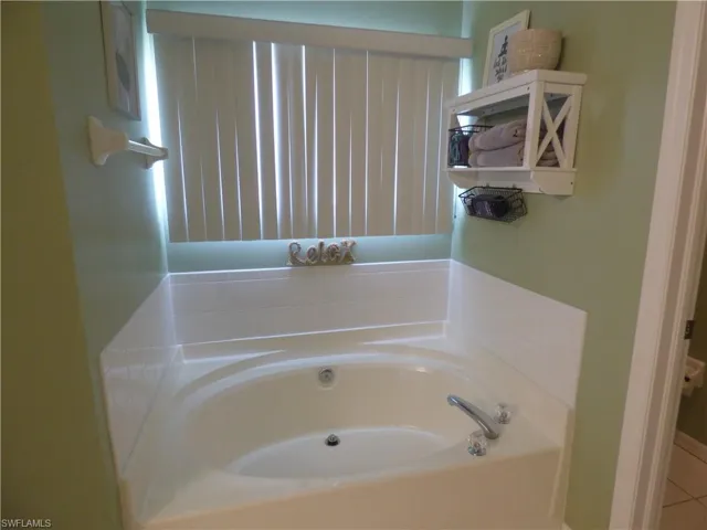 Bathroom featuring a Garden tub and tile floors